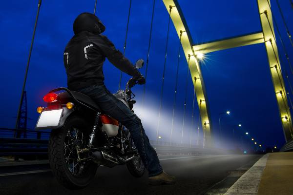 a bike rider crossing a metal bridge