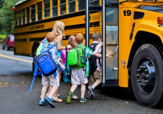 los niños suben al autobús escolar