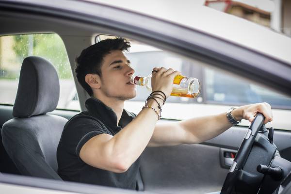 a man drinks and drives in the streets of texas