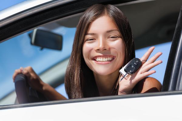 female teen excited because she just got her drivers license 